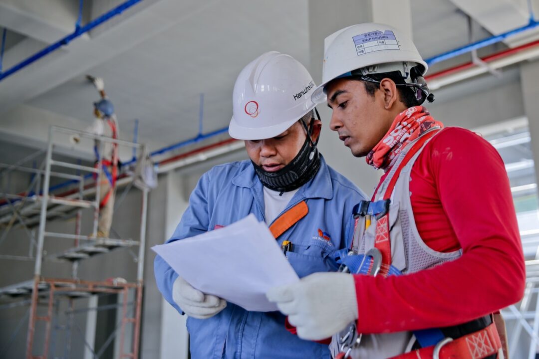 Construction workers looking at plans